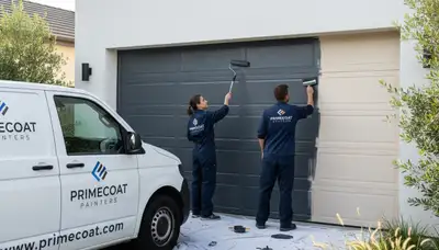 Professional painters applying fresh garage door paint in Royal Oak, MI for lasting curb appeal
